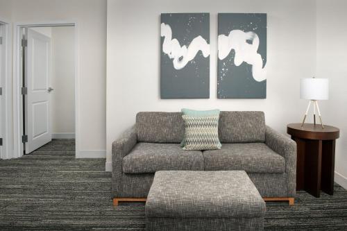 a living room with a couch and a table at TownePlace Suites by Marriott Cheyenne Southwest/Downtown Area in Cheyenne