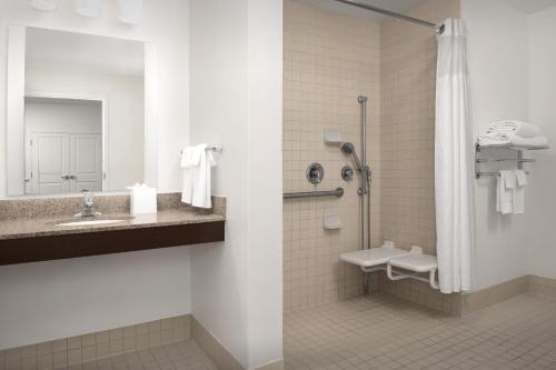 a bathroom with a shower and a sink and a toilet at TownePlace Suites by Marriott Cheyenne Southwest/Downtown Area in Cheyenne