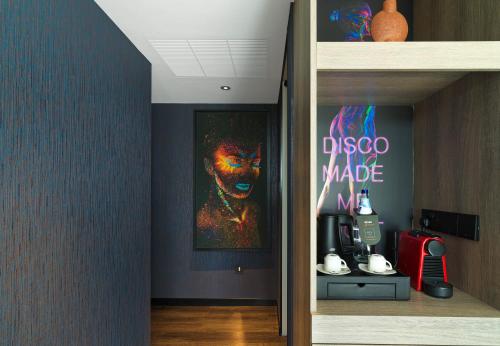 a room with a painting of a woman on the wall at NYX Hotel Limassol in Limassol