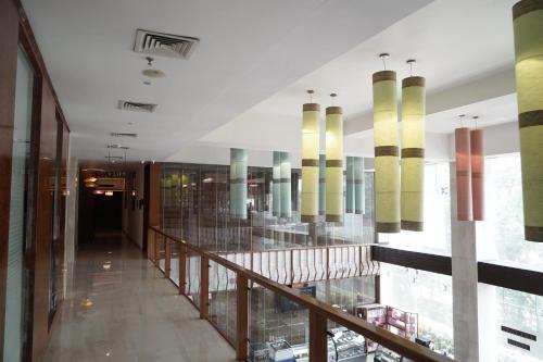 a hallway of a building with a glass wall at The Alcor Hotel in Jamshedpur