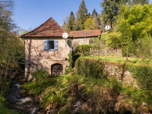 an old stone house with a window on a hill at Holiday Home Roucan by Interhome in Teyssieu
