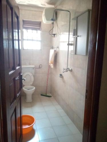 a bathroom with a toilet and a shower at Serene 1 Bedroom Cozy Apartment in a fancy mall in Najjera in Kampala