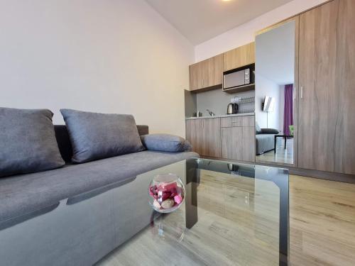 a living room with a couch and a glass table at Sapareva Apartments in Sapareva Banya