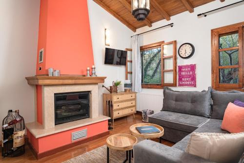 a living room with a couch and a fireplace at Stone Nest in Samos