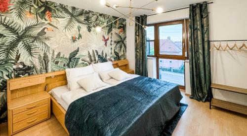 a bedroom with a bed and a wall with a mural at VALEMI BohoChic Aptmt in TopLage mit Küche&Parkplatz&Balkon in Landsberg am Lech