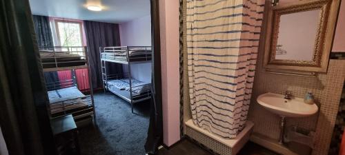 a bathroom with a sink and a mirror at Hostel Kiezbude in Hamburg