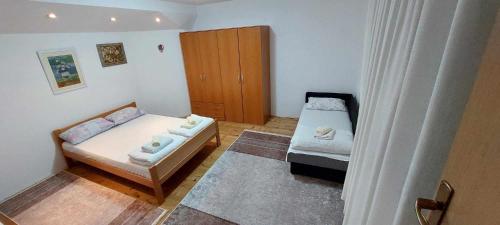 a small room with a bed and a cabinet at Apartman u Kuci u Konjicu in Konjic