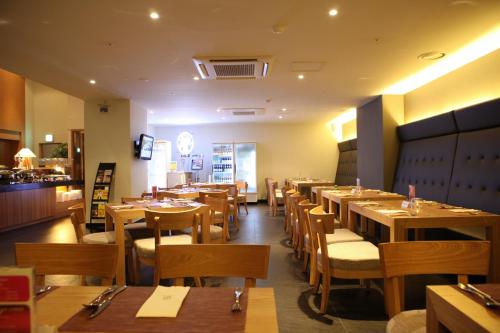 a dining room with wooden tables and chairs at Grammos Hotel in Seoul