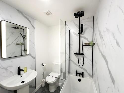 a white bathroom with a sink and a shower at Aristotle House by Blue Skies Stays in Stockton-on-Tees