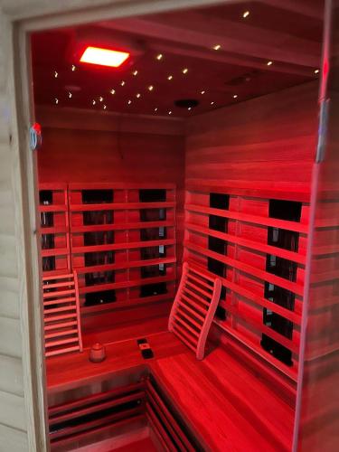 a red room with two red chairs in it at The Fehmarn Lodges - OASIS - in Fehmarn