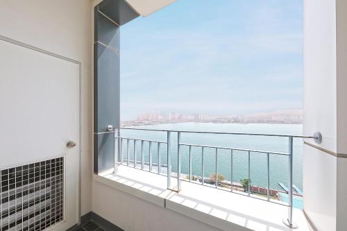 a balcony with a view of the ocean at World Sky Residence Hotel in Sokcho