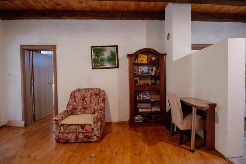 a living room with a chair and a table at Omni S Apartments in Bar