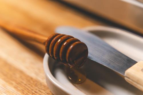 a honey spoon with a wooden handle on a knife at Danhostel Aarhus City in Aarhus