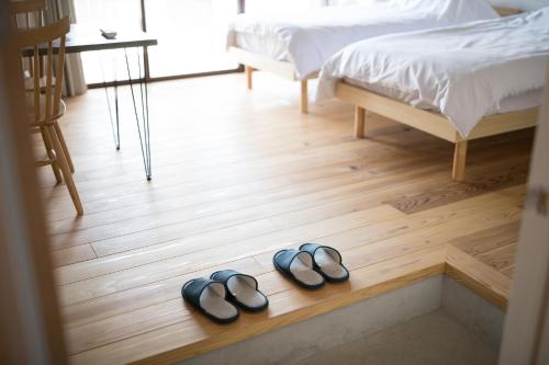 Una cama o camas en una habitación de ホステル Cabin