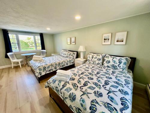 a bedroom with a bed and a couch and a table at Sandy Neck Motel in Sandwich