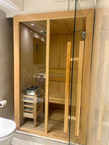 a glass shower in a bathroom with a toilet at Palm Beach apartment Bissone in Bissone