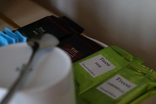 a close up of a pair of tongs next to a group of books at Villa Nonna Cicci Boutique Hotel - SPA in Cisterna dʼAsti