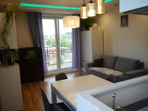 a living room with a couch and a table at Najlepszy Apartament Sikorskiego in Olsztyn