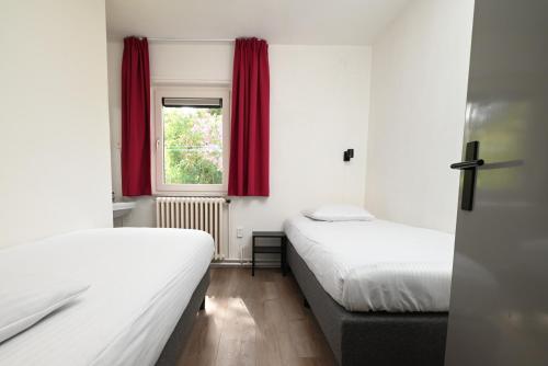 Postel nebo postele na pokoji v ubytování Nor Saga - Hennequinlaan 10