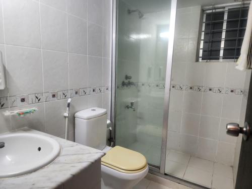 a bathroom with a shower and a toilet and a sink at Allegro Suites, Cox's Bazar in Cox's Bazar