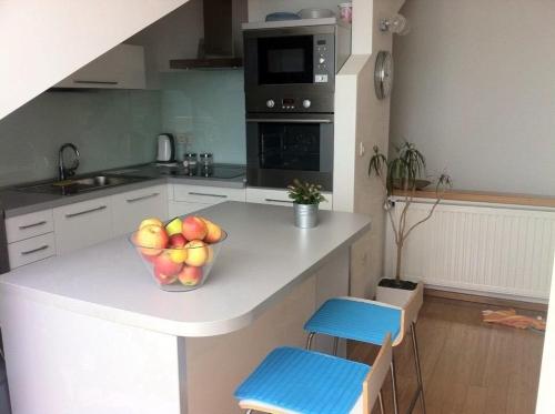 a kitchen with a bowl of apples on a counter at Penthouse Villa Spomenka top floor apartment on central beach in Podgora