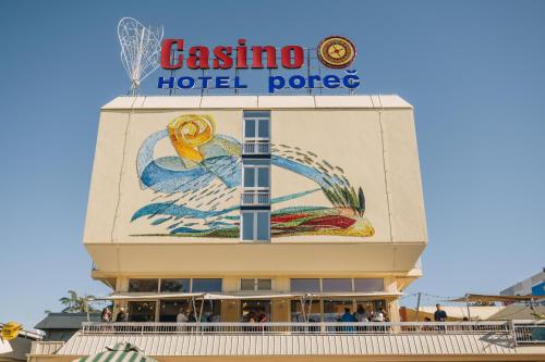 a sign on the top of a casino hotel palace at Hotel Porec in Poreč