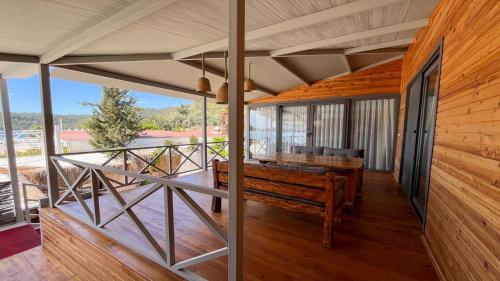 a wooden porch with a bench on a deck at Beach 222 Oludeniz in Fethiye