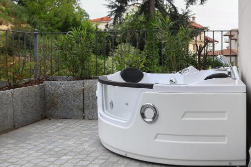 a white bath tub sitting on a patio at Villa Nonna Cicci Boutique Hotel - SPA in Cisterna dʼAsti