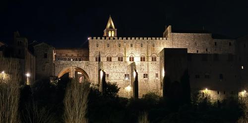 a large castle at night with a tower on top at aCasetta GuestHouse in Viterbo
