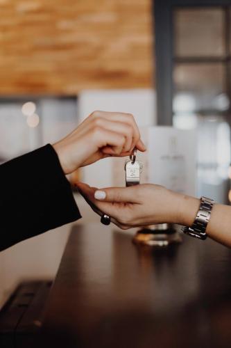 a person handing another person a small bottle of drugs at L'Hôtel Bristol in Caen