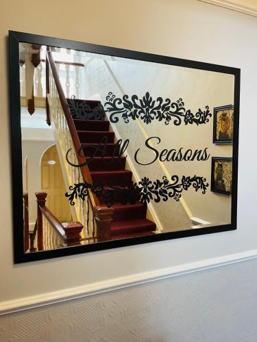a picture of a staircase with a sign that says seasons at All Seasons Bed & Breakfast - Adults Only in Weston-super-Mare