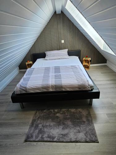 利希特瑙的住宿－FeWo Elke Lichtenau，阁楼上的卧室配有一张大床