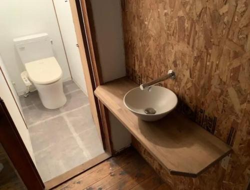 鹿児島市にあるGrandma's House Kakuregaの洗面台とトイレ付きのバスルーム