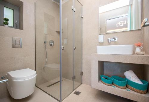 a bathroom with a shower and a toilet and a sink at Villa MANDI & JANI in Laganas