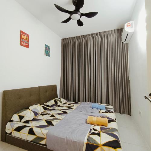 a bedroom with a bed and a ceiling fan at Comfortable18 3R2B 7pax Meritus Perai in Perai