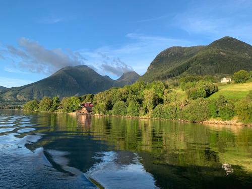 a view of a river with mountains in the background at Guddals Tunet in Rosendal
