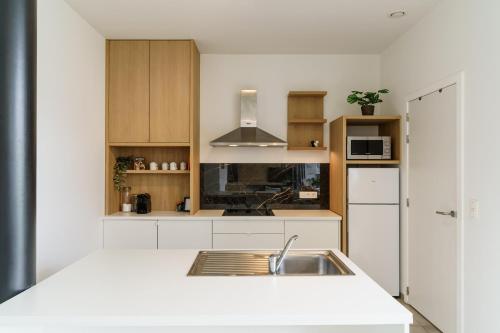 a kitchen with white cabinets and a sink at Nr 28 TravelHome in Heusden - Zolder