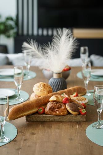 a table with a plate of bread and pastries on it at Nr 28 TravelHome in Heusden - Zolder