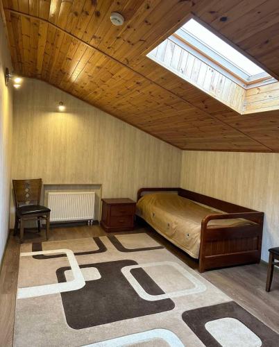 a bedroom with a bed and a skylight at Готель-ресторан Chalet in Bila Tserkva
