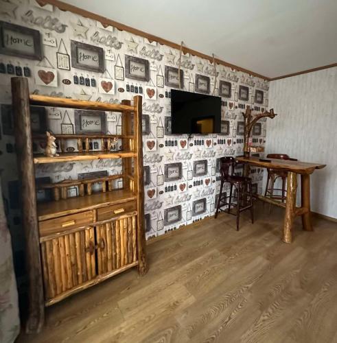 a living room with a wall with pictures on it at Готель-ресторан Chalet in Bila Tserkva