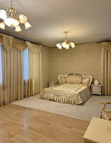 a bedroom with a bed and a chandelier at Готель-ресторан Chalet in Bila Tserkva