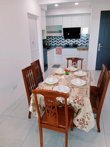 a dining room with a table with chairs and a tableablish at Preferred30 3R2B 7pax Meritus Perai in Perai