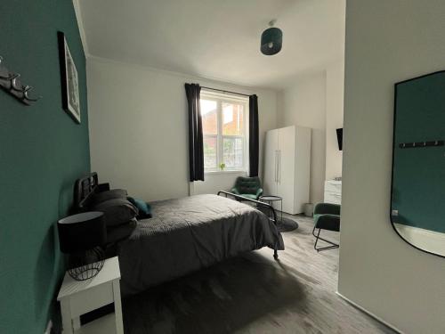a bedroom with a bed and a large window at Myrtle Villas in Hull