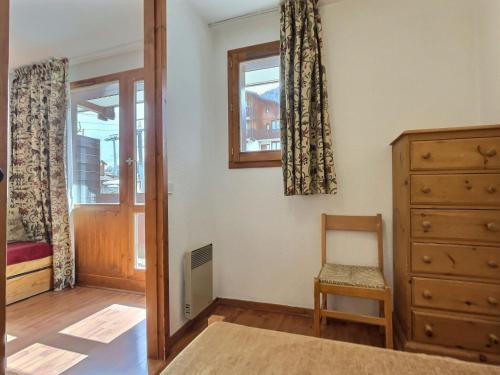 een slaapkamer met een dressoir, een stoel en een raam bij Appartement Val-d'Isère, 2 pièces, 4 personnes - FR-1-411-153 in Val dʼIsère