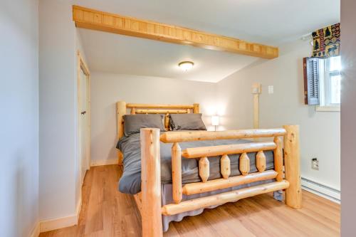 a bedroom with a wooden bed in a room at Cottage with Deck and Bluff Lake Views Walk to Beach! in Lake