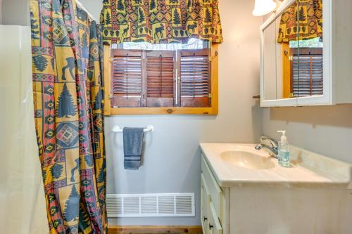 a bathroom with a sink and a window at Cottage with Deck and Bluff Lake Views Walk to Beach! in Lake