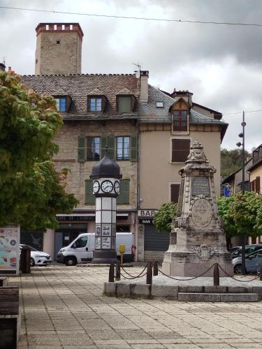 a clock tower in front of a building at La Cadisserie en Gévaudan in Marvejols