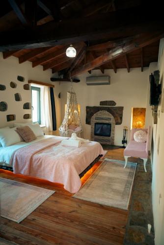a bedroom with a large bed and a fireplace at Areto Konak Otel in Dereköy
