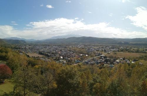 an aerial view of a town with mountains in the background at Yukiumi House in Kamikawa