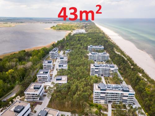 an aerial view of the beach and condos at Apartament na Sosnowej Wydmie - Osiedle Shellter in Rogowo